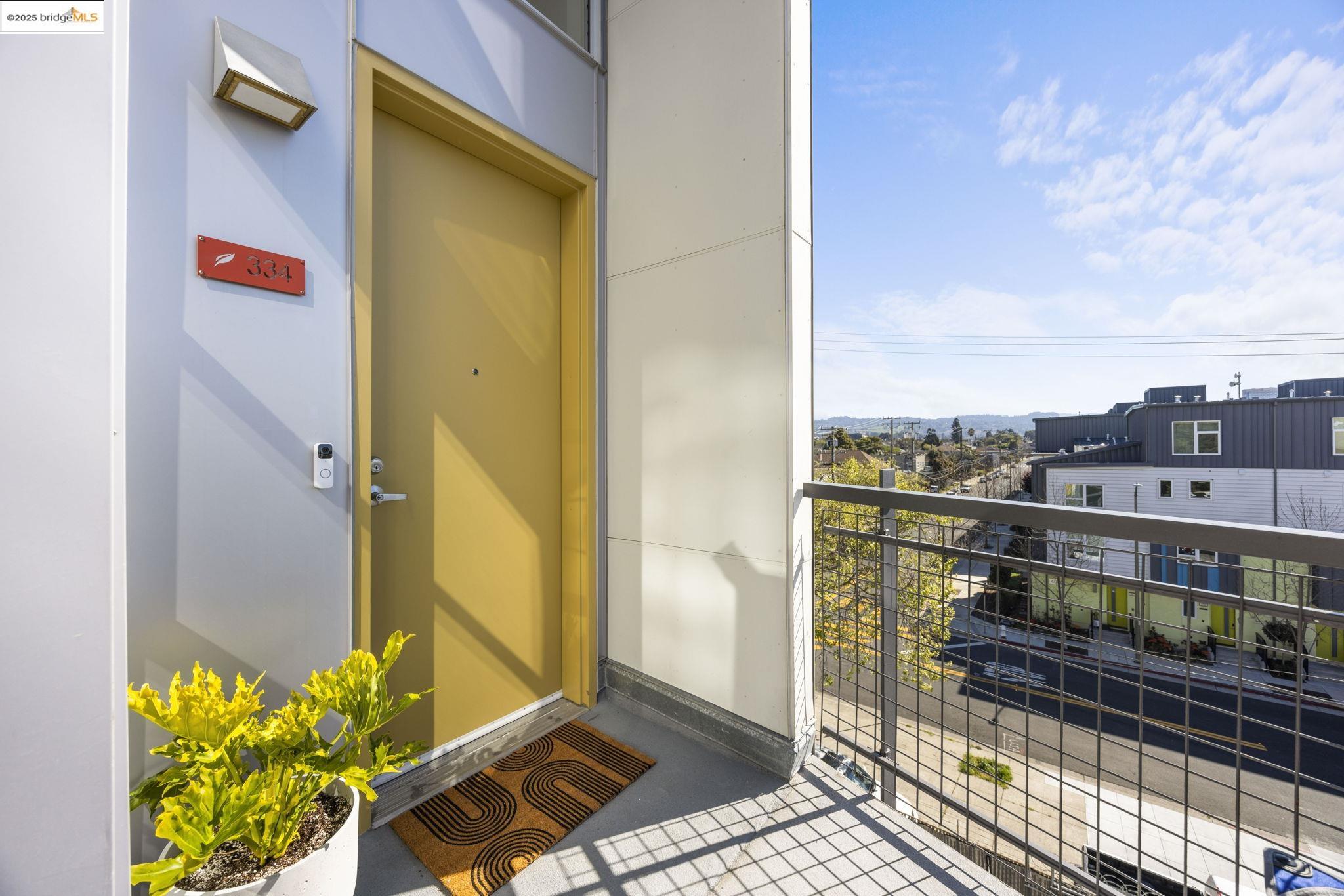 1007 41st Street, Unit 334 Oakland, CA 94608 - Photo 48 of 59 a view of a balcony with wooden floor and a potted plant