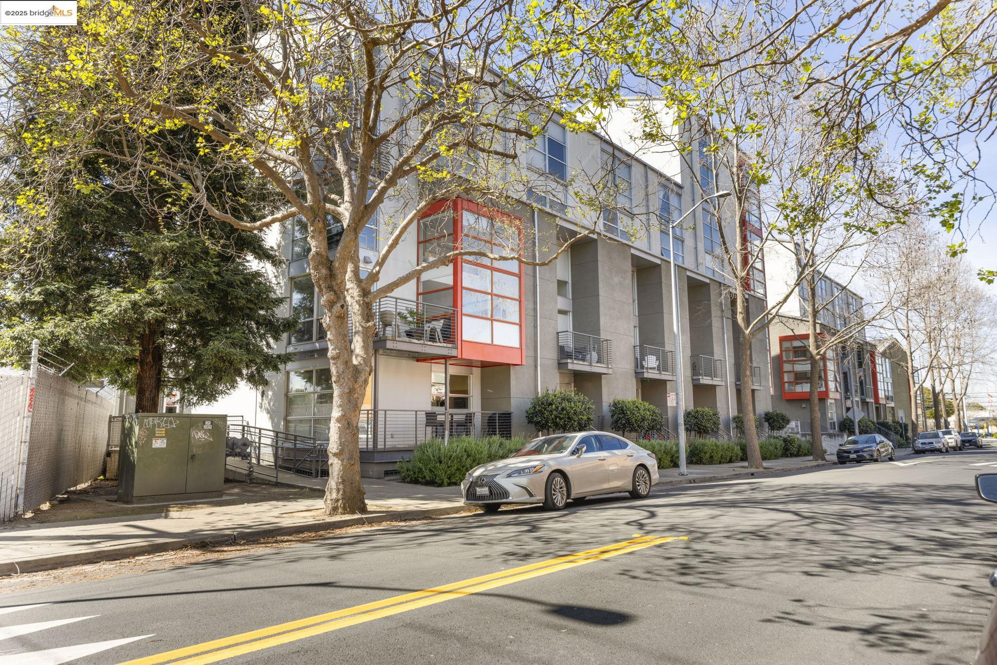 1007 41st Street, Unit 334 Oakland, CA 94608 - Photo 56 of 59 a white house that has a tree in front of it