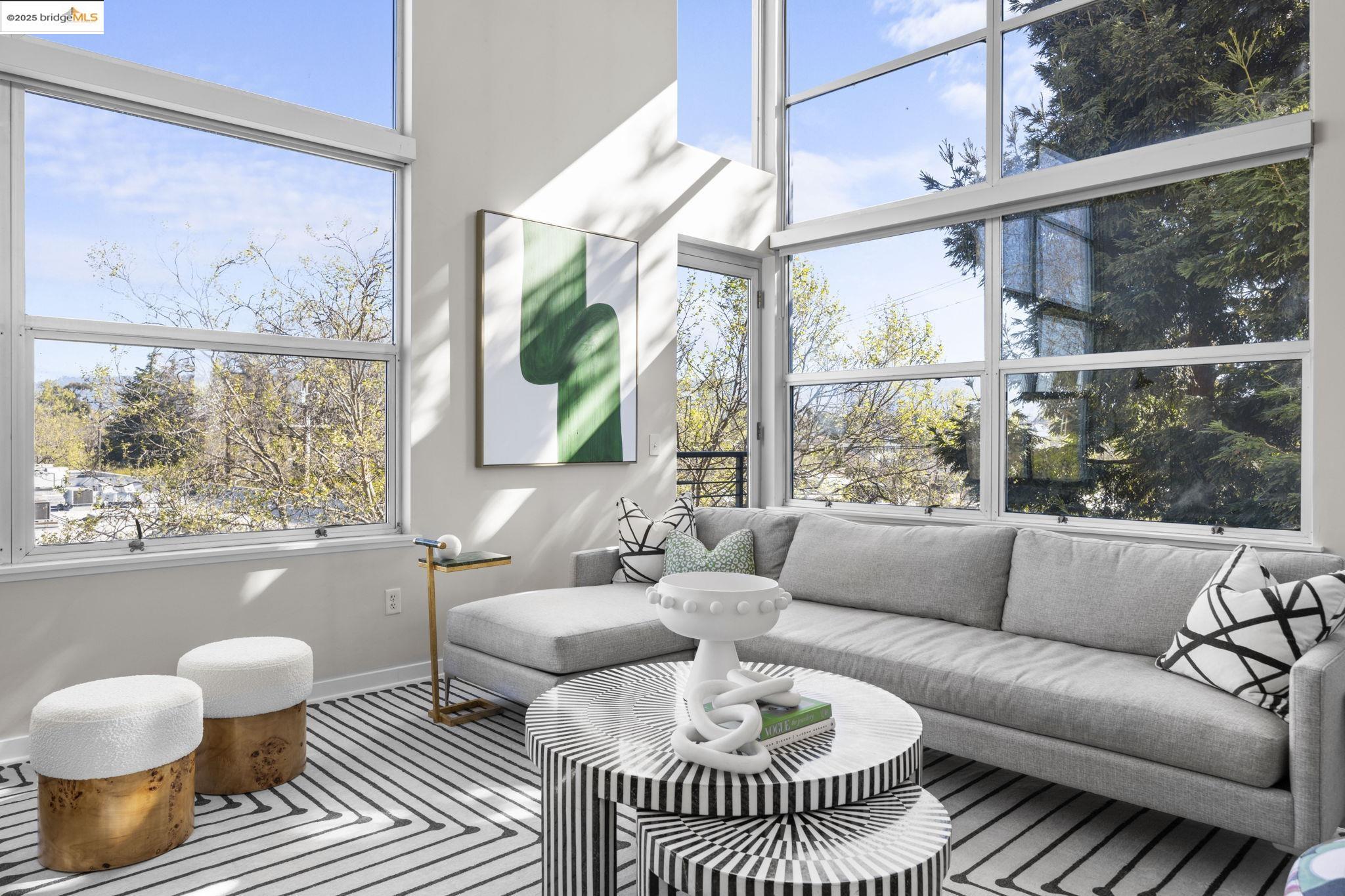 1007 41st Street, Unit 334 Oakland, CA 94608 - Photo 6 of 59 a living room with furniture and a large window