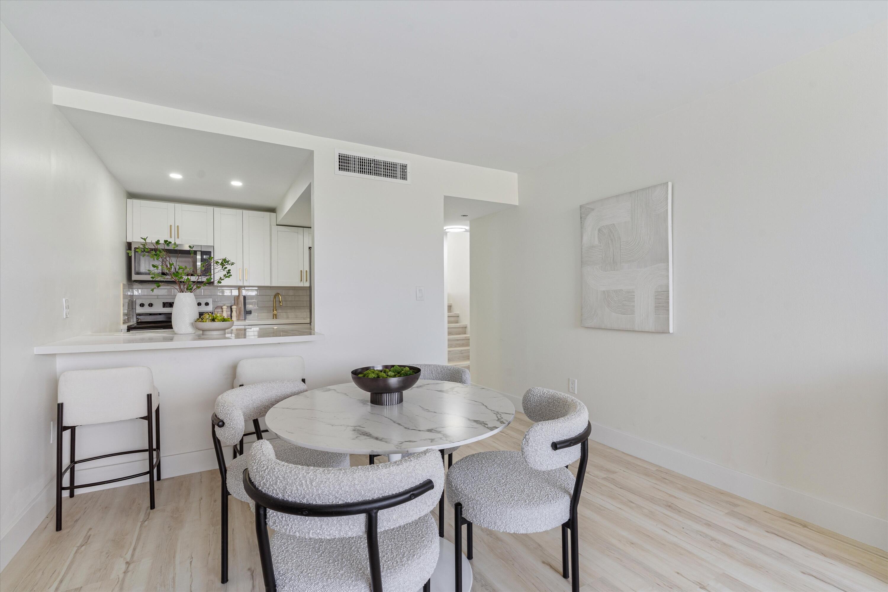 755 Dotterel Road, Unit 1307 Delray Beach, FL 33444 - Photo 13 of 36 a view of a dining room with furniture and wooden floor