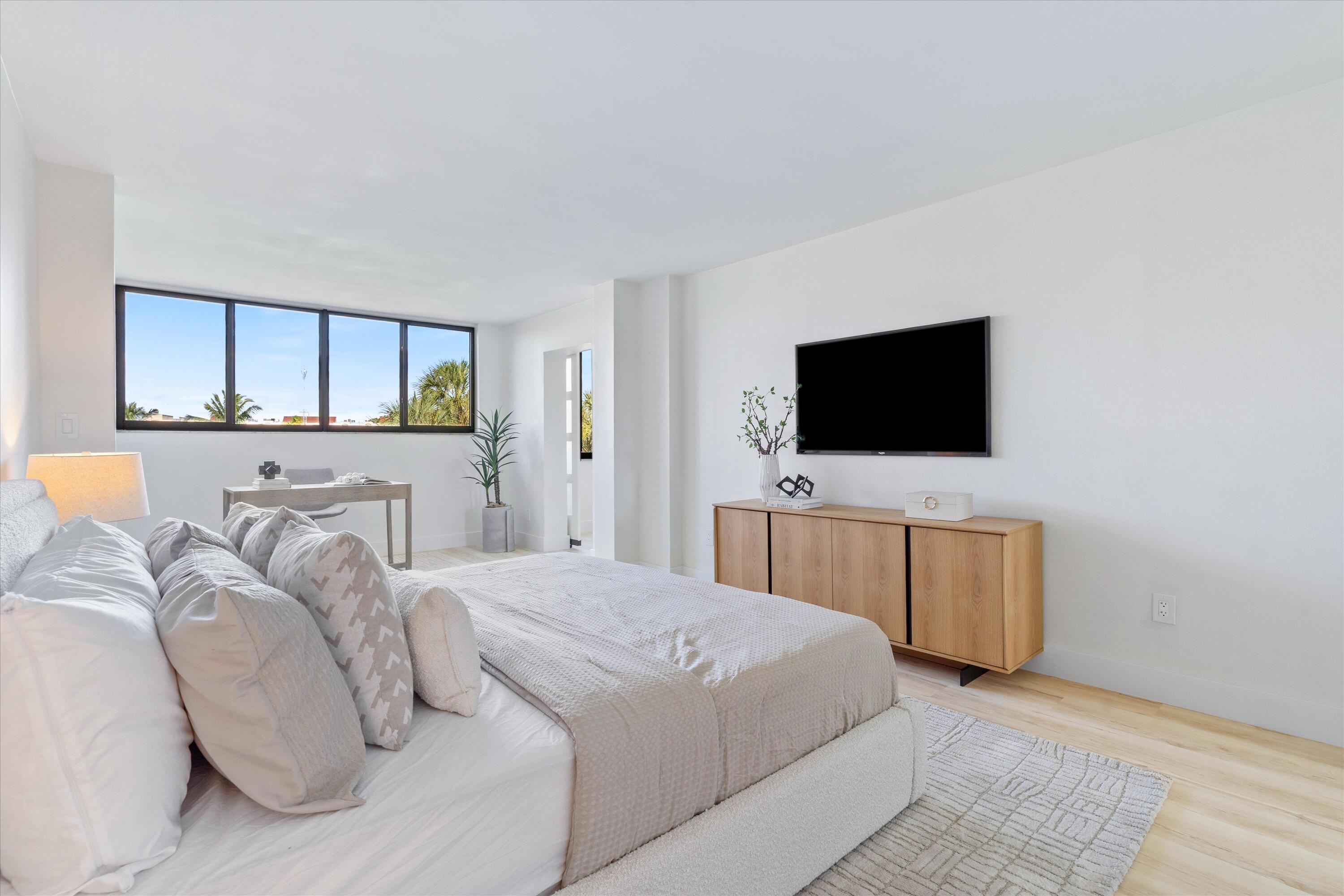 755 Dotterel Road, Unit 1307 Delray Beach, FL 33444 - Photo 15 of 36 a bedroom with a bed and a flat screen tv