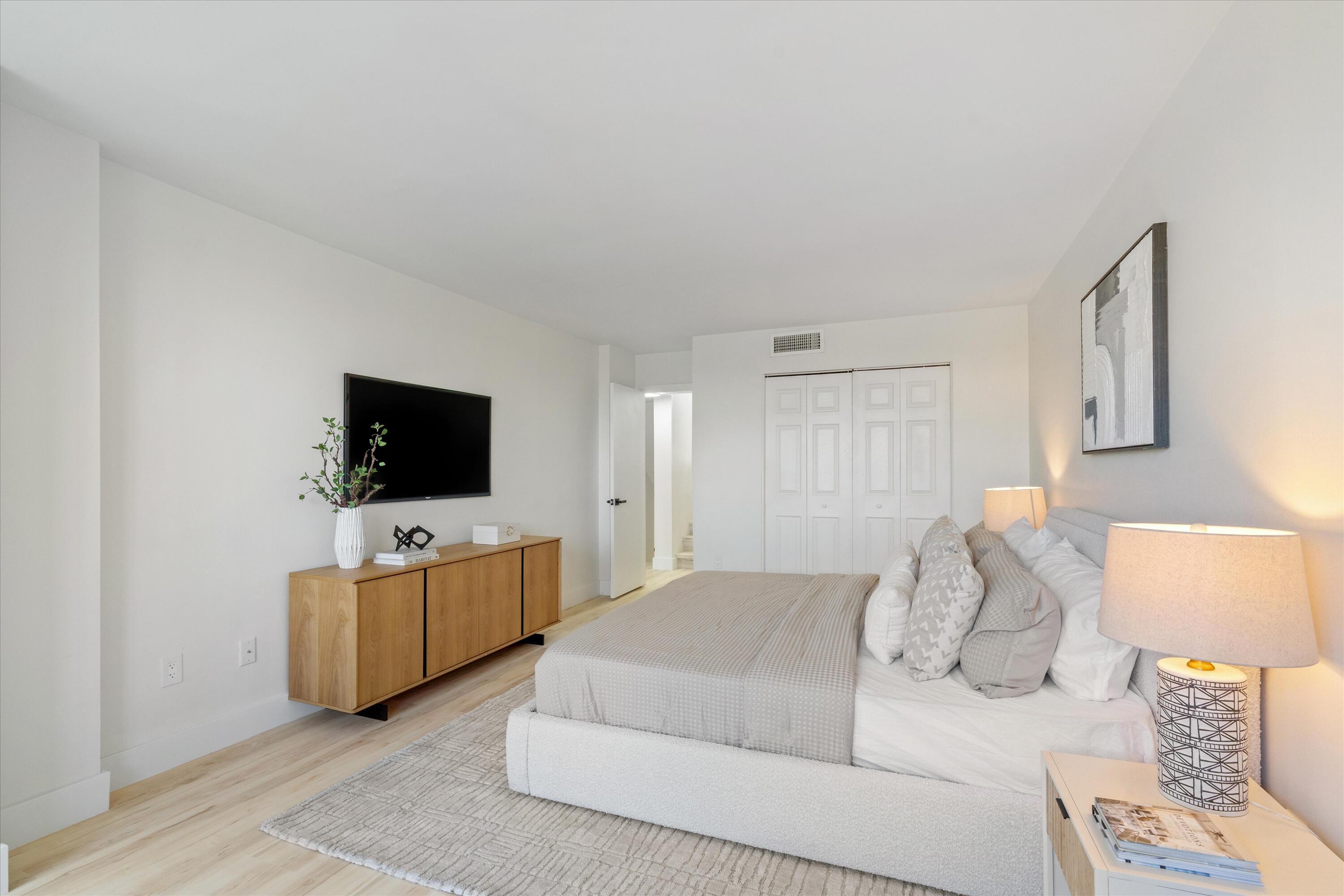755 Dotterel Road, Unit 1307 Delray Beach, FL 33444 - Photo 17 of 36 a bedroom with a bed and flat screen tv