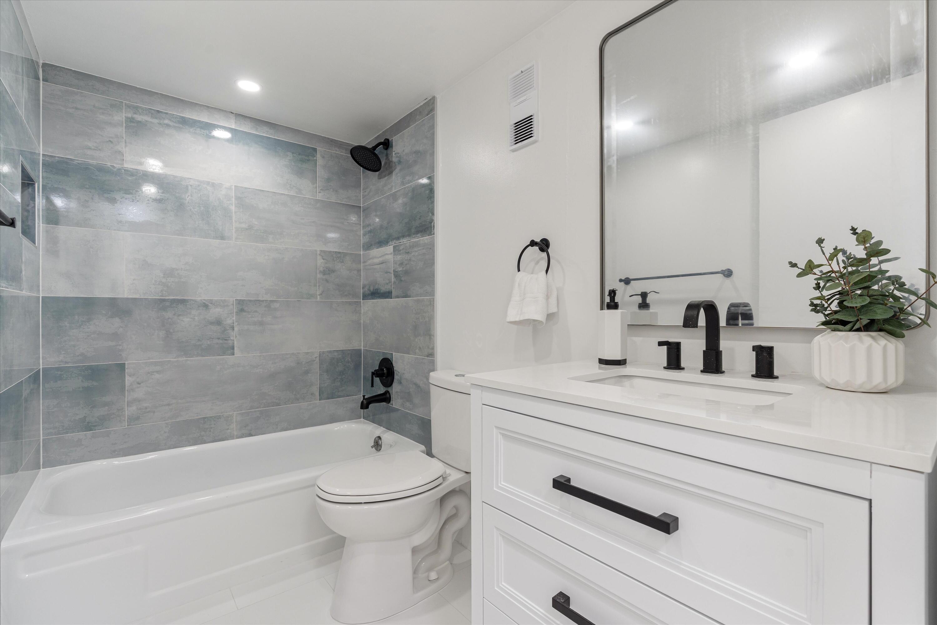 755 Dotterel Road, Unit 1307 Delray Beach, FL 33444 - Photo 21 of 36 a bathroom with a sink a toilet and shower