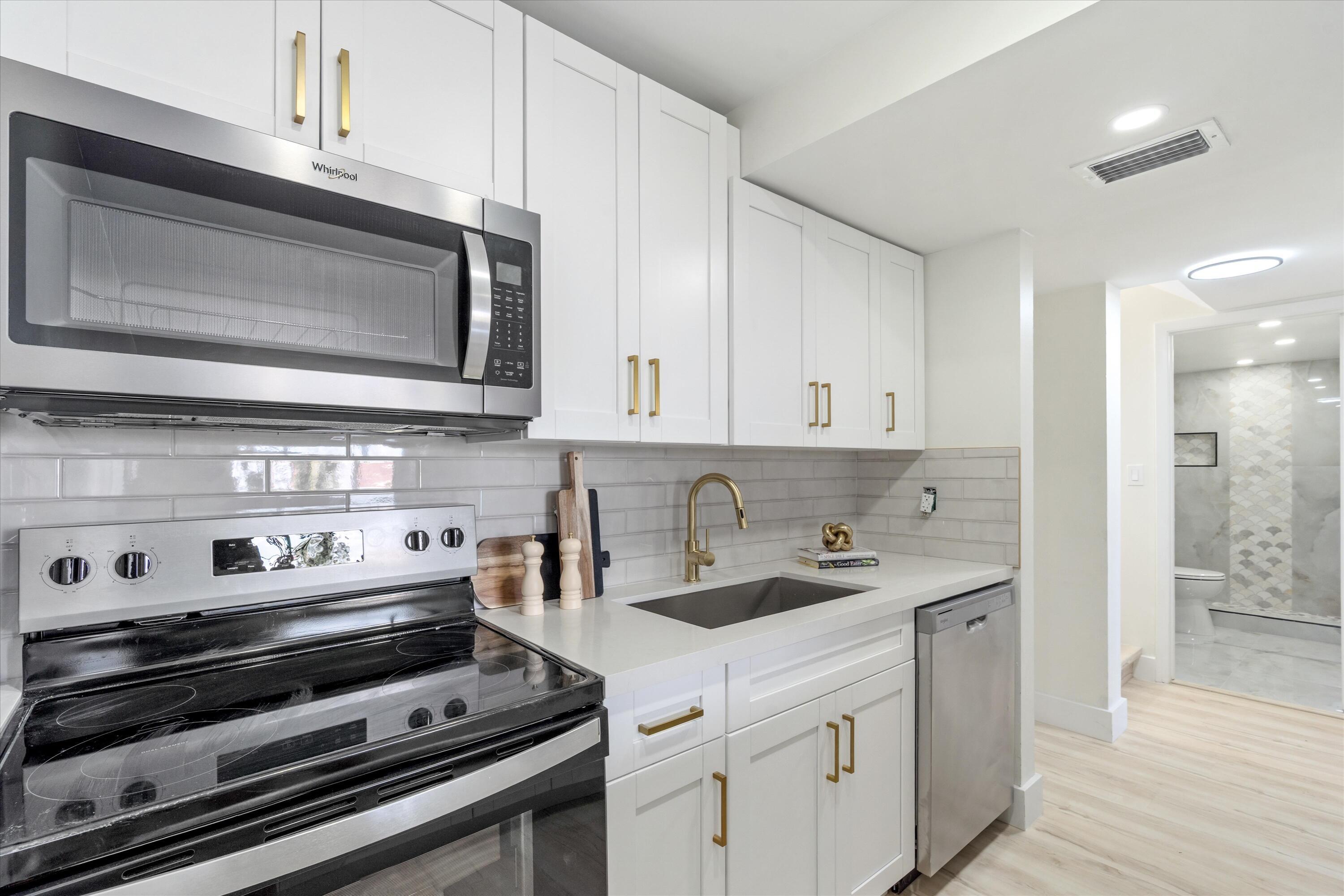 755 Dotterel Road, Unit 1307 Delray Beach, FL 33444 - Photo 10 of 36 a kitchen with a stove and a microwave