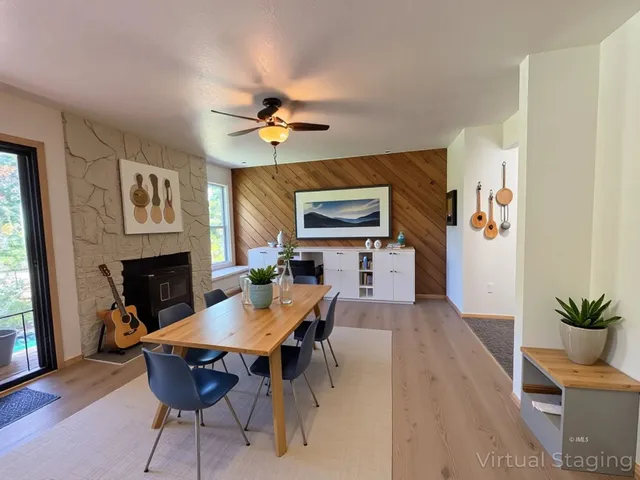 a living room with furniture a bookshelf and a window