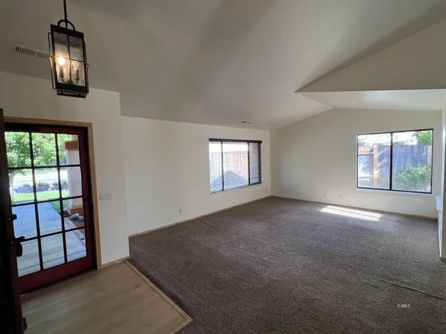 a kitchen with stainless steel appliances granite countertop a sink a stove and a refrigerator
