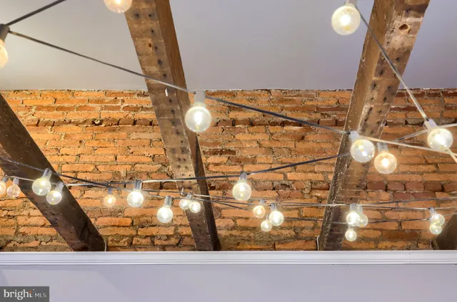 a view of a backyard with table and chairs and wooden fence
