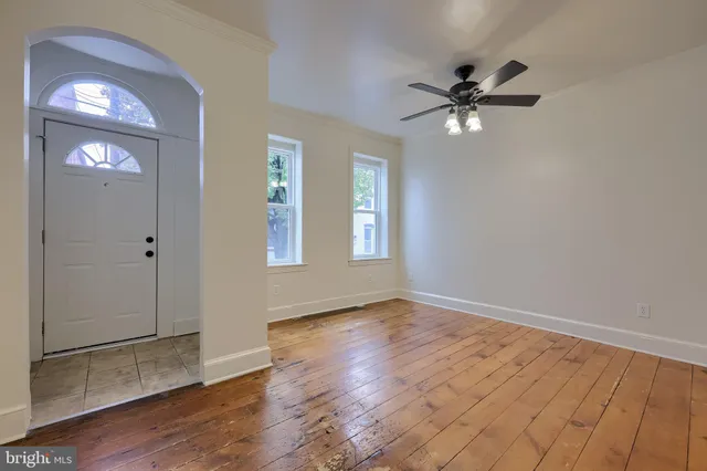 wooden floor in an empty room with a window