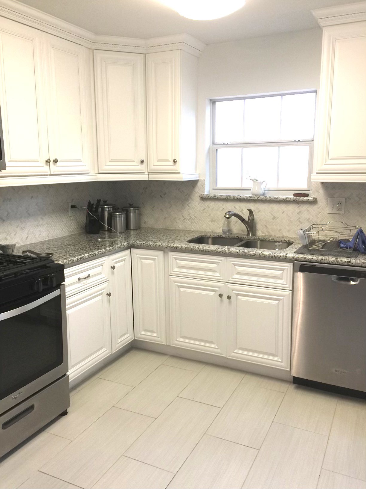 4416 Holt Street Bellaire, TX 77401 - Photo 2 of 12 a kitchen with granite countertop white cabinets and white appliances