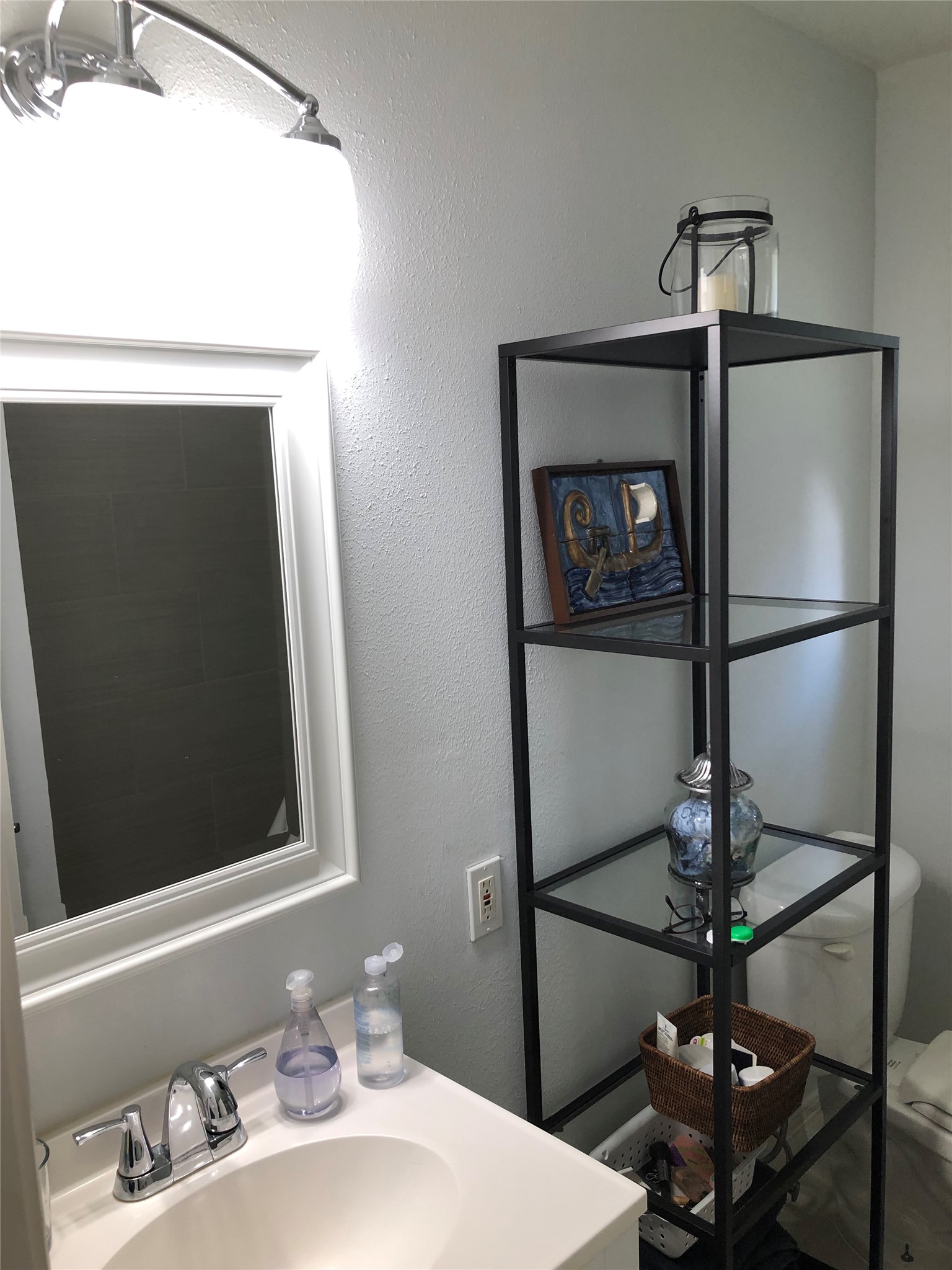 4416 Holt Street Bellaire, TX 77401 - Photo 7 of 12 a bathroom with a sink and a mirror