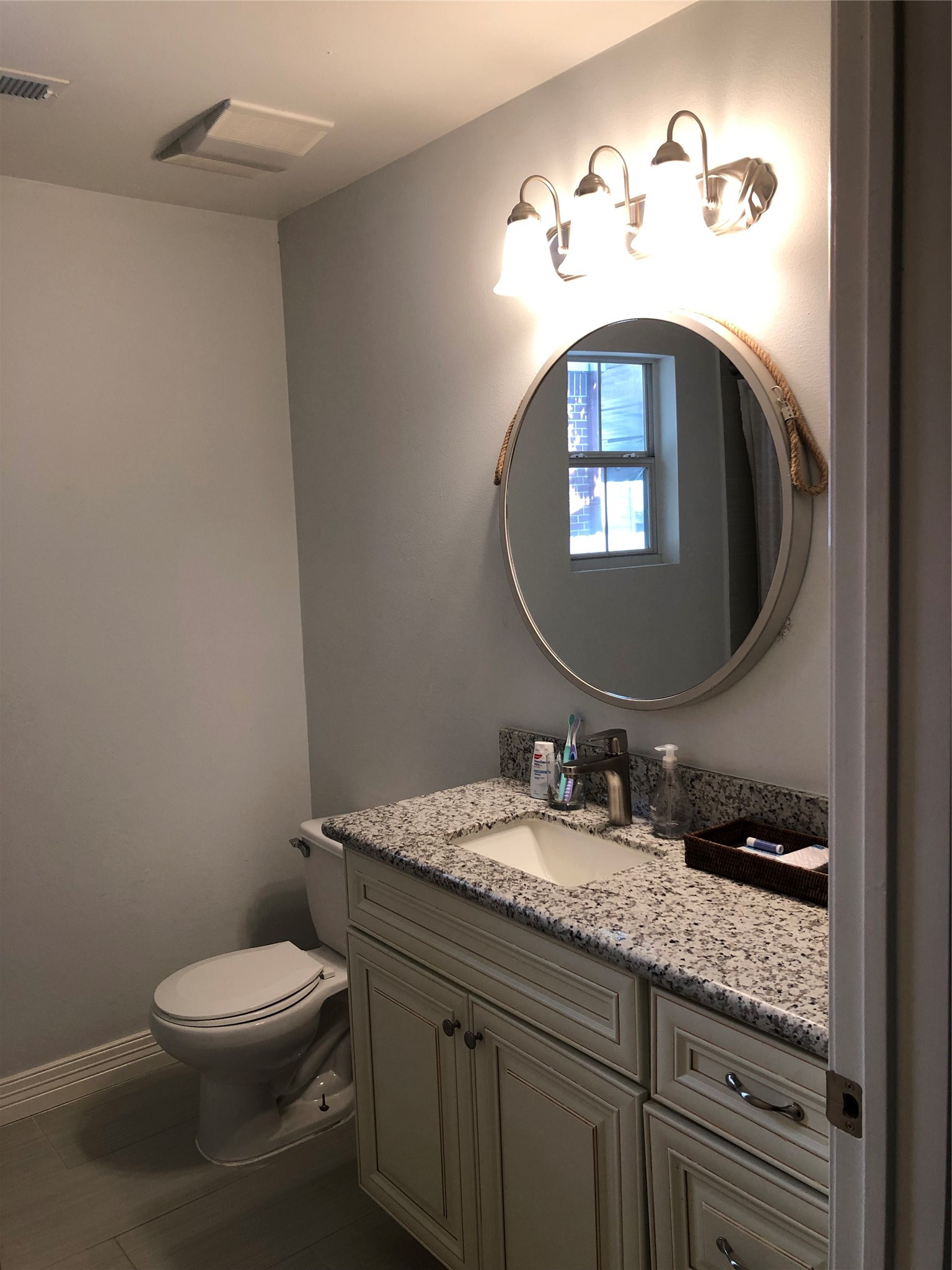 4416 Holt Street Bellaire, TX 77401 - Photo 9 of 12 a bathroom with a toilet sink and mirror