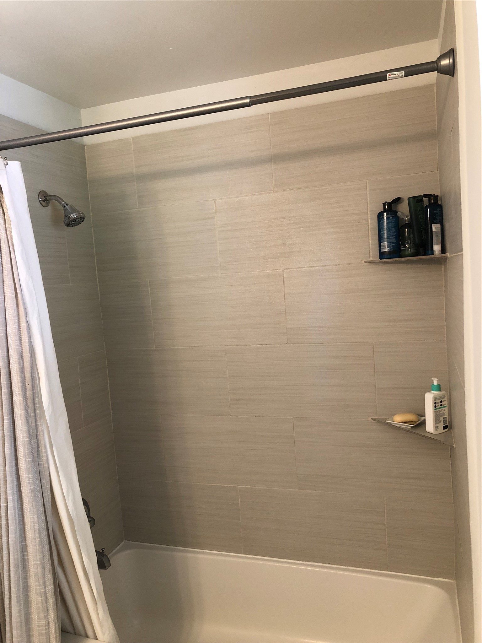 4416 Holt Street Bellaire, TX 77401 - Photo 10 of 12 a bathroom with a shower and a bath tub