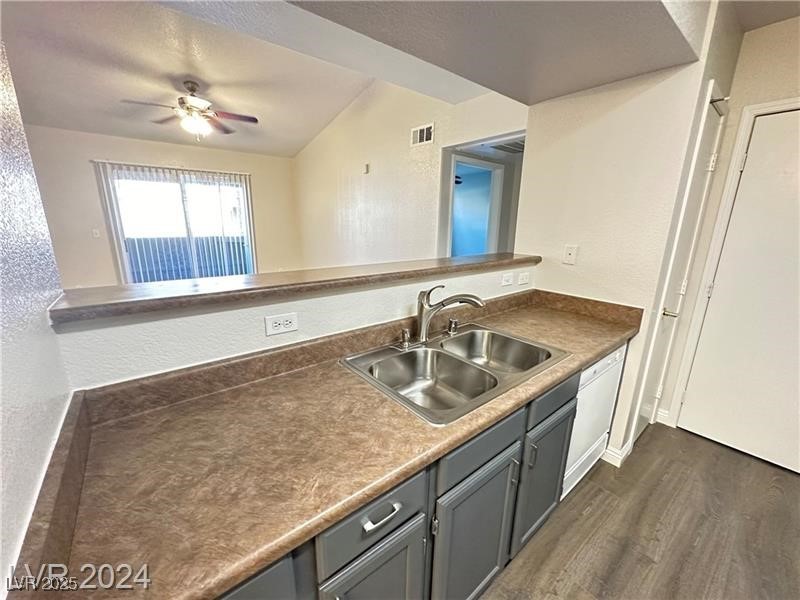 6650 West Warm Springs Road, Unit 2007 Las Vegas, NV 89118 - Photo 14 of 26 Kitchen with a textured wall, dark wood-style flooring, dark countertops, gray cabinets, and ceiling fan
