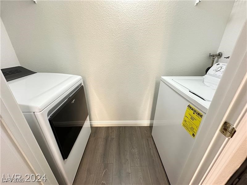 6650 West Warm Springs Road, Unit 2007 Las Vegas, NV 89118 - Photo 20 of 26 Washroom featuring washing machine and clothes dryer, dark wood-style floors, and a textured wall