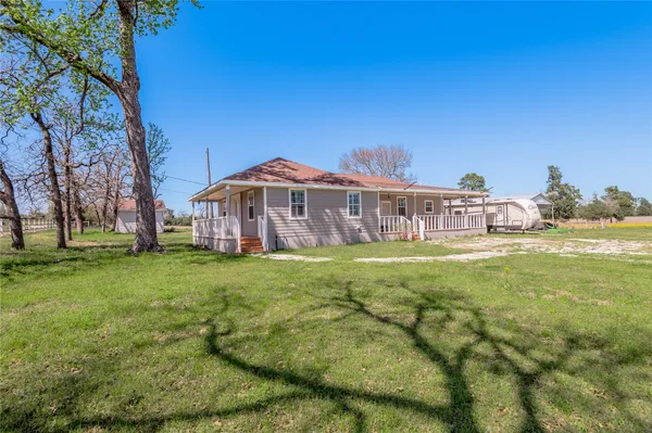 a view of a house with a yard table and chairs