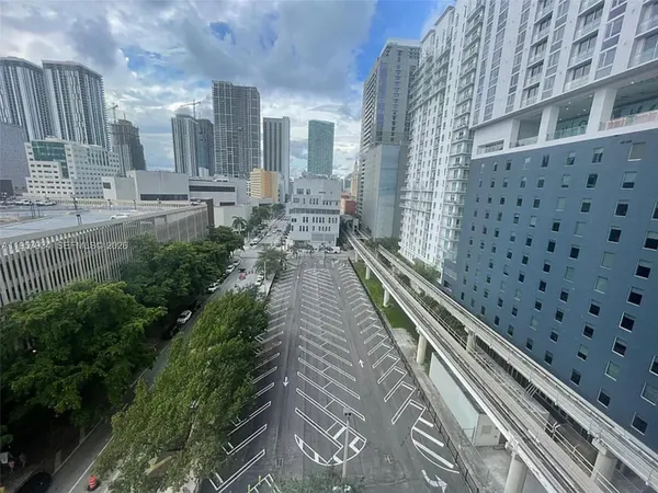 a white toilet sitting next to a bathroom sink and a shower