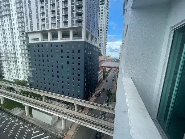 a view of balcony with wooden floor and fence