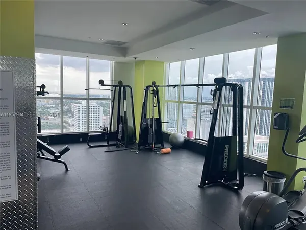 a large bed sitting in a bedroom and a chandelier