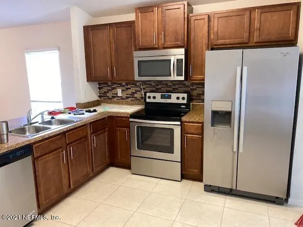 a kitchen with a refrigerator sink and microwave