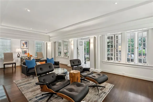a living room with furniture and floor to ceiling windows
