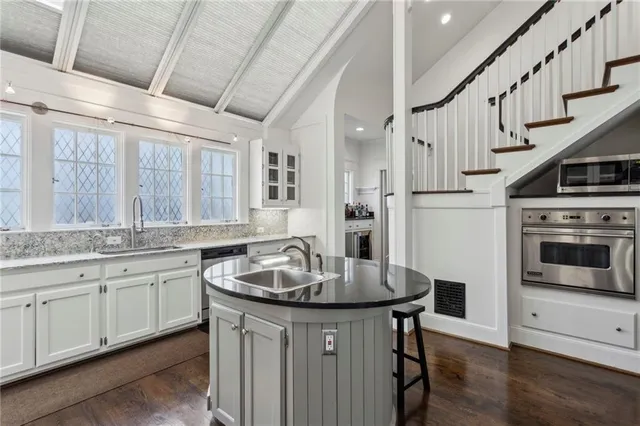 a kitchen with sink and white cabinets