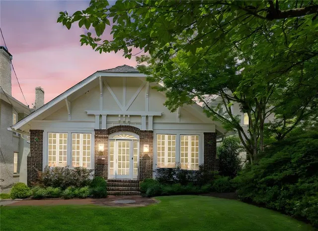 a front view of a house with a garden