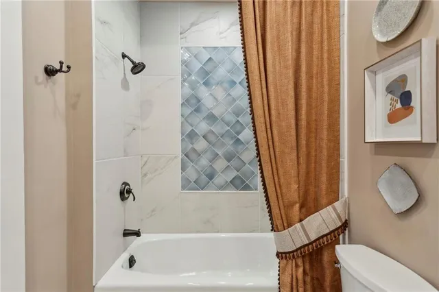 a bathroom with a shower curtain and a sink