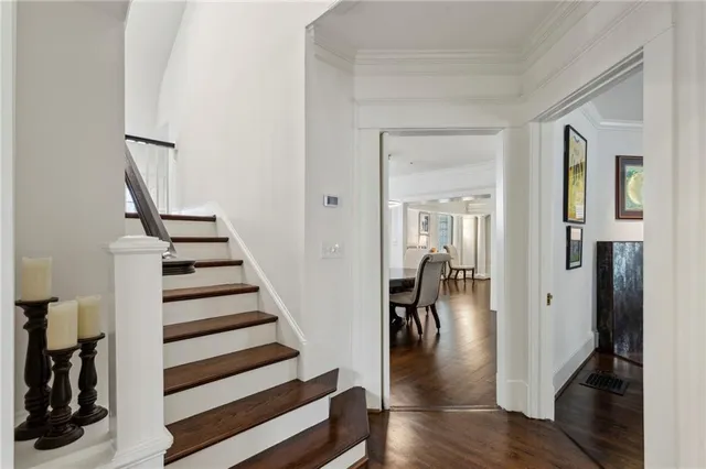 a view of a hallway with wooden floor and workspace