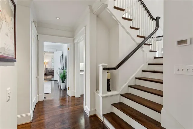 a view of a hallway with wooden floor and entryway