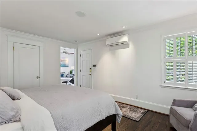 a bedroom with a bed couch and a window