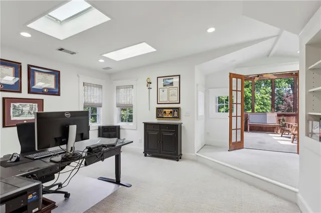 a view of a livingroom with furniture and a flat screen tv