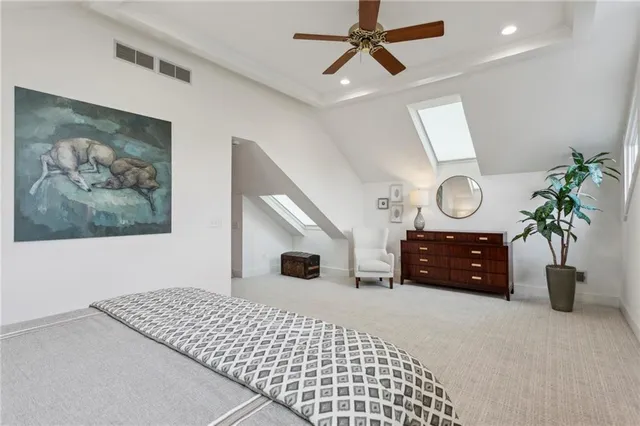 a bedroom with a bed chandelier and a window