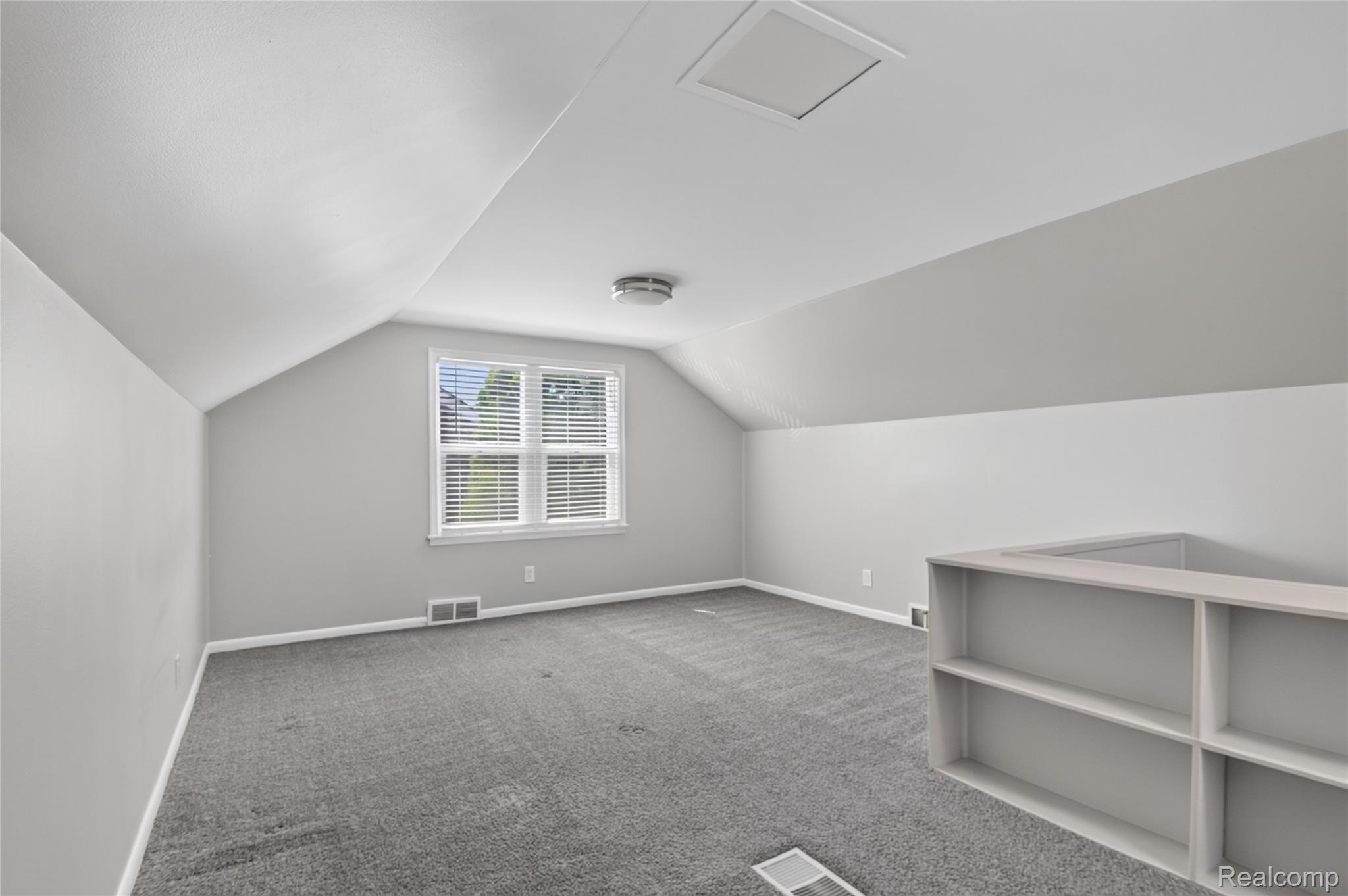 12972 Callender Street Southgate, MI 48195 - Photo 27 of 40 Carpeted room with sloped ceilings, a double window with blinds, and built-in shelving
