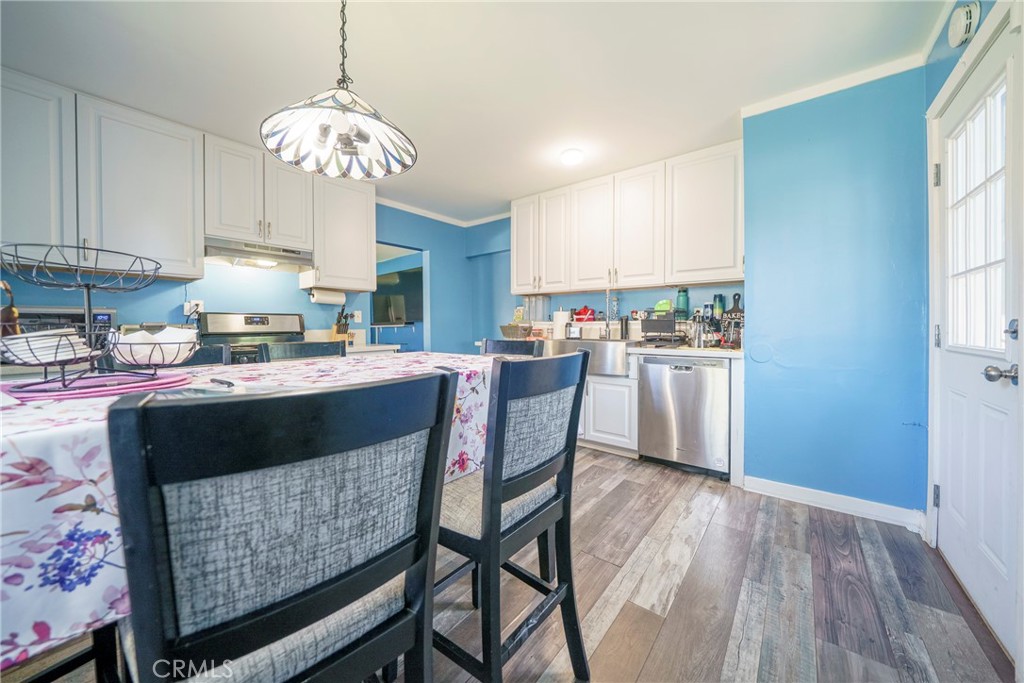 2137 Pepper Drive Highland, CA 92346 - Photo 12 of 35 a kitchen with a table chairs and a refrigerator