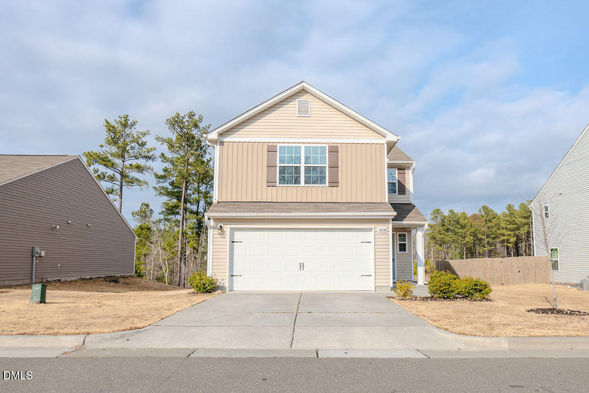 a front view of a house with a yard and garage