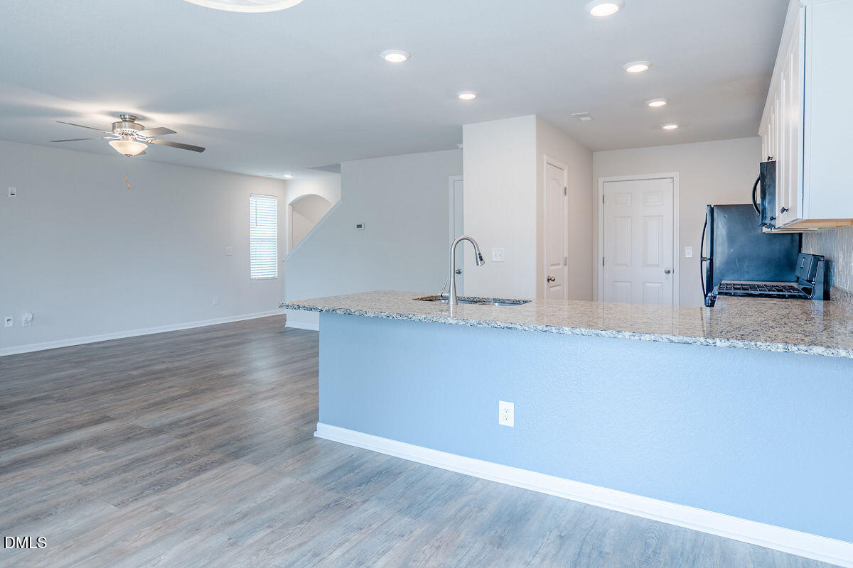 2036 Alderman Way Creedmoor, NC 27522 - Photo 11 of 49 a view of kitchen with granite countertop cabinets and wooden floor