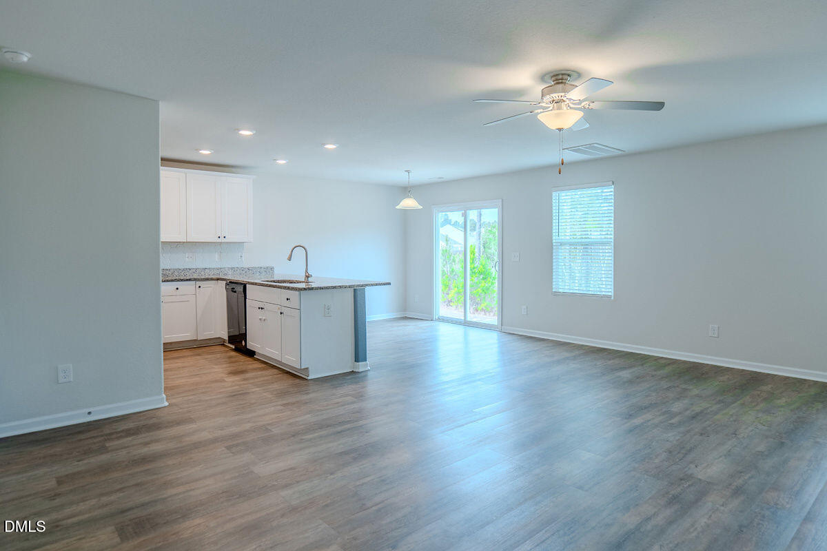 2036 Alderman Way Creedmoor, NC 27522 - Photo 16 of 49 a view of a kitchen with a sink dishwasher cabinets and a large window