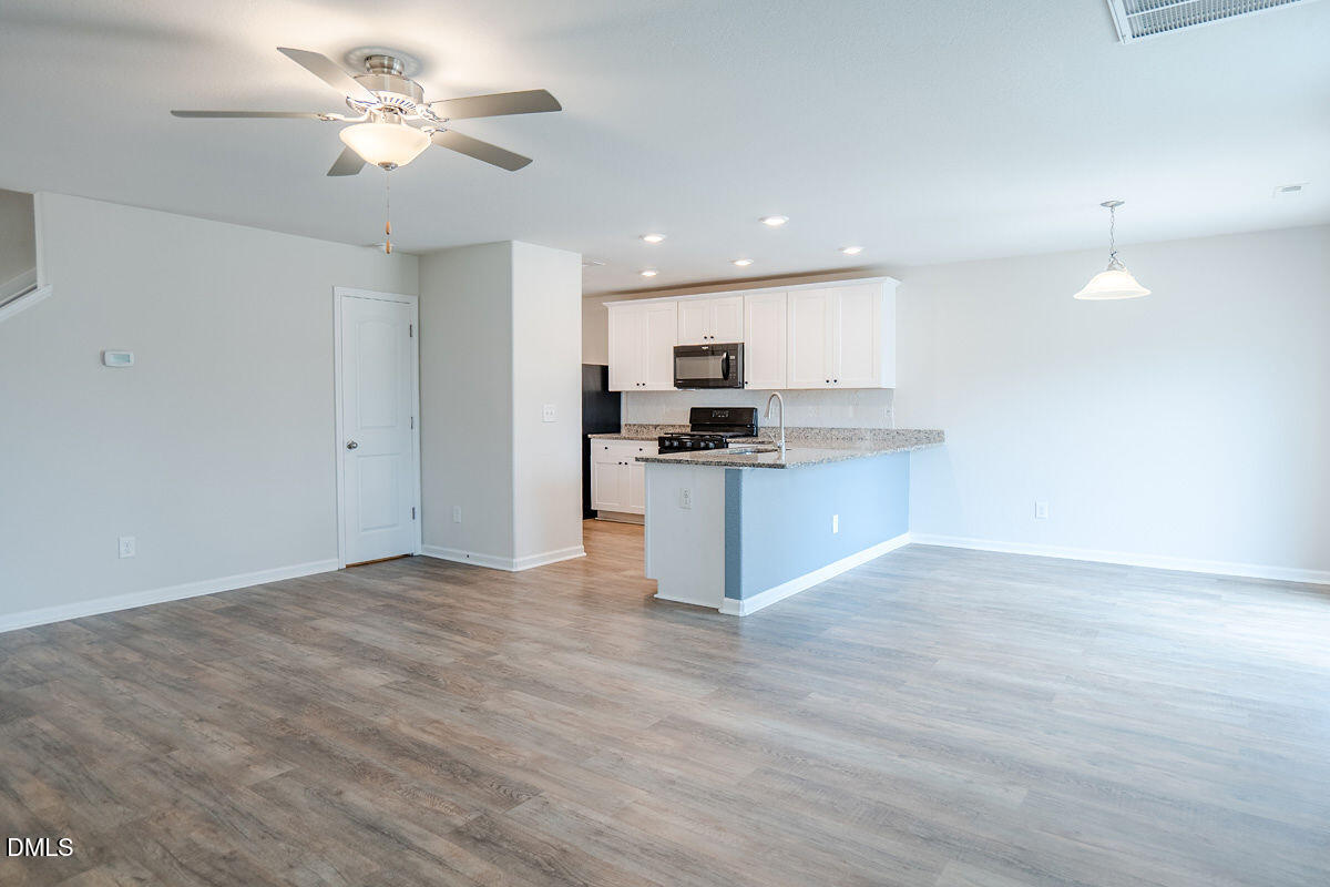 2036 Alderman Way Creedmoor, NC 27522 - Photo 17 of 49 a view of kitchen with granite countertop cabinets and stainless steel appliances