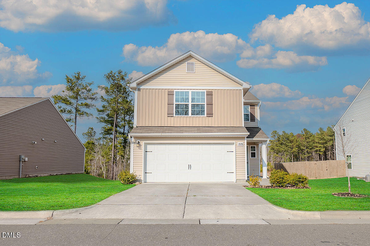 2036 Alderman Way Creedmoor, NC 27522 - Photo 2 of 49 a front view of a house with a yard and garage