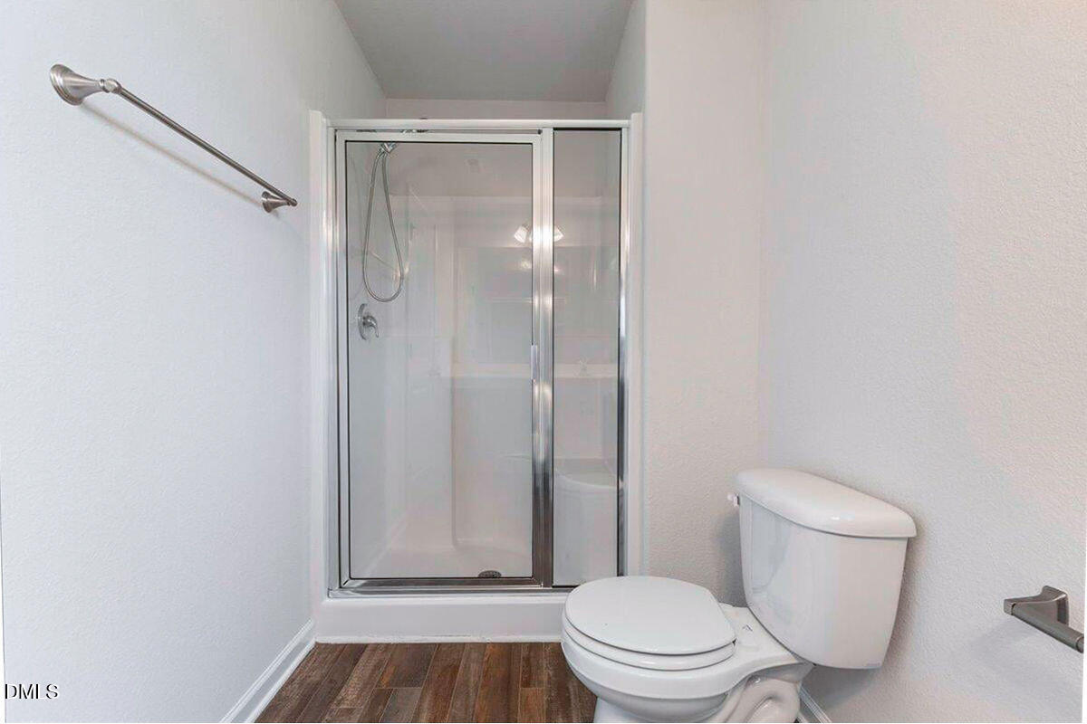 2036 Alderman Way Creedmoor, NC 27522 - Photo 36 of 49 a bathroom with a granite countertop toilet and a shower