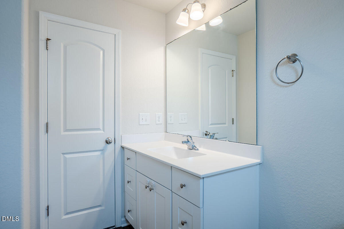 2036 Alderman Way Creedmoor, NC 27522 - Photo 37 of 49 a bathroom with a sink vanity and mirror