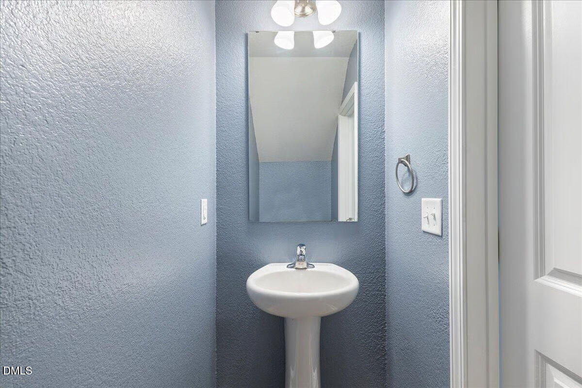 2036 Alderman Way Creedmoor, NC 27522 - Photo 38 of 49 a bathroom with a sink and a mirror