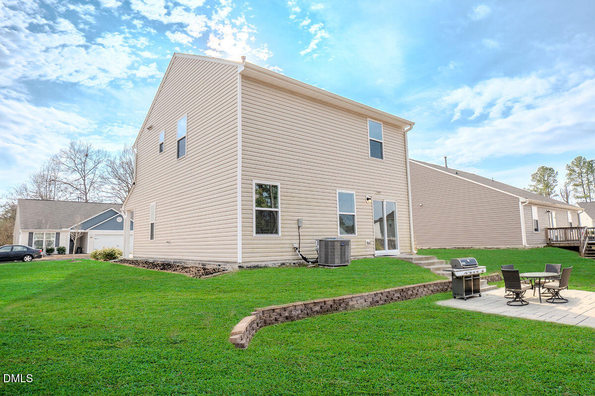 2036 Alderman Way Creedmoor, NC 27522 - Photo 45 of 49 a view of backyard with a garden and deck