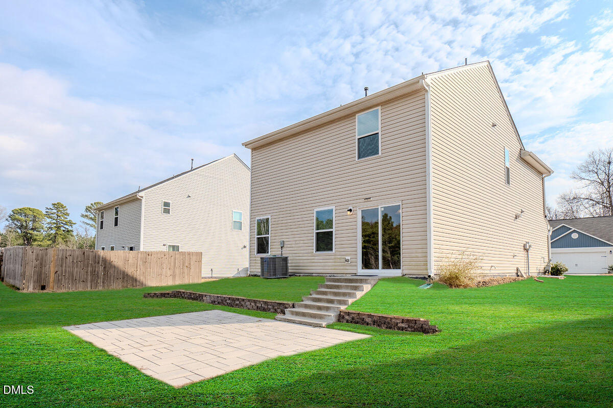 2036 Alderman Way Creedmoor, NC 27522 - Photo 49 of 49 a view of a white house with a yard and wooden fence