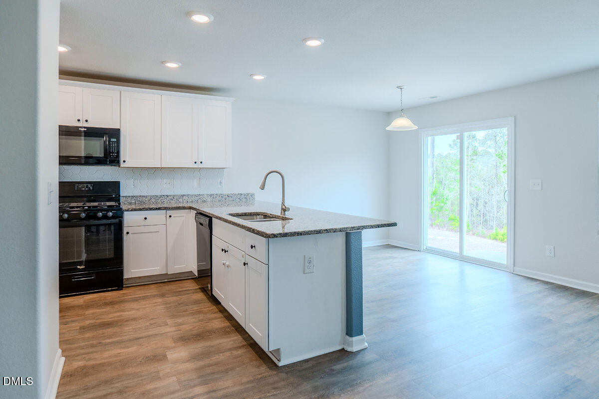 2036 Alderman Way Creedmoor, NC 27522 - Photo 9 of 49 a kitchen with a sink stove and refrigerator