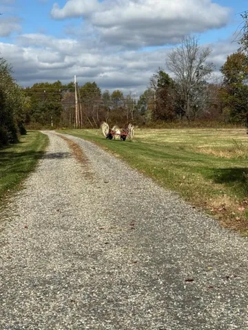 a view of a field with sitting area