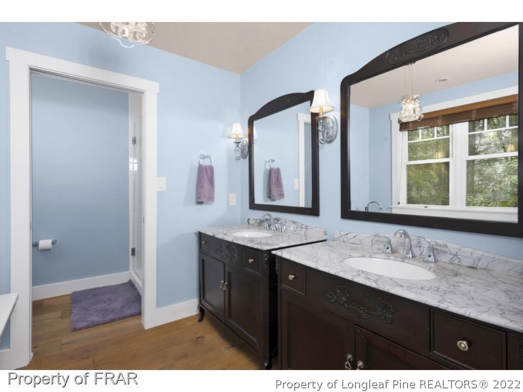 6839 Uppingham Road Fayetteville, NC 28306 - Photo 20 of 36 a bathroom with a granite countertop sink mirror and double