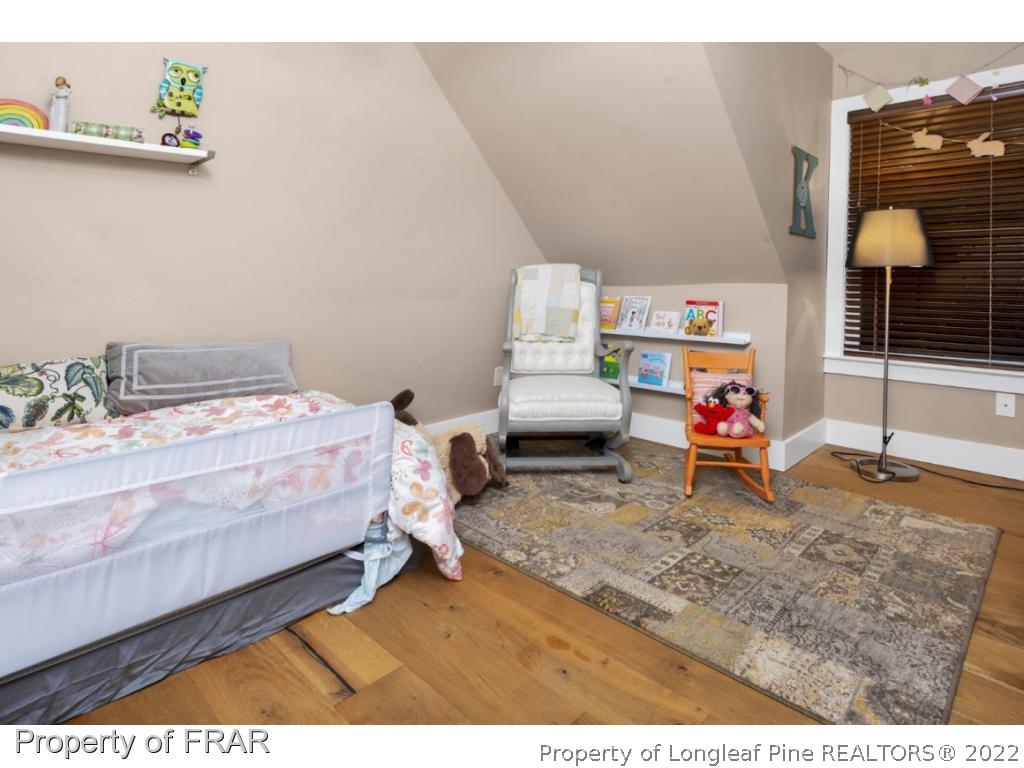 6839 Uppingham Road Fayetteville, NC 28306 - Photo 29 of 36 a bed room with a bed and a table