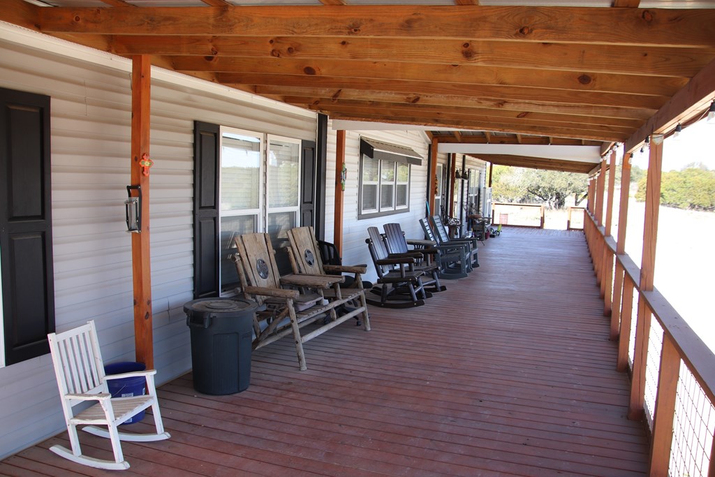 20120 Other Rocksprings, TX 78880 - Photo 9 of 20 a view of a patio with table and chairs and wooden floor