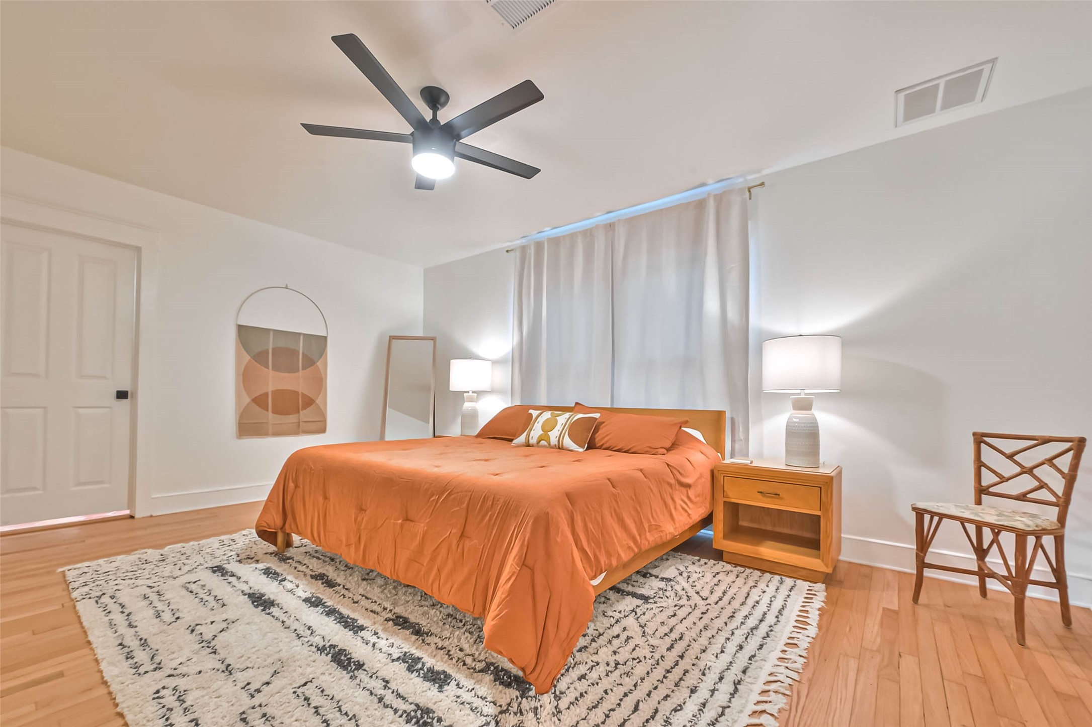 412 Sue Street Houston, TX 77009 - Photo 10 of 19 This spacious first floor primary bedroom features warm wood flooring, two large windows for abundant natural light and a stylish ceiling fan. Spacious walk in closet.